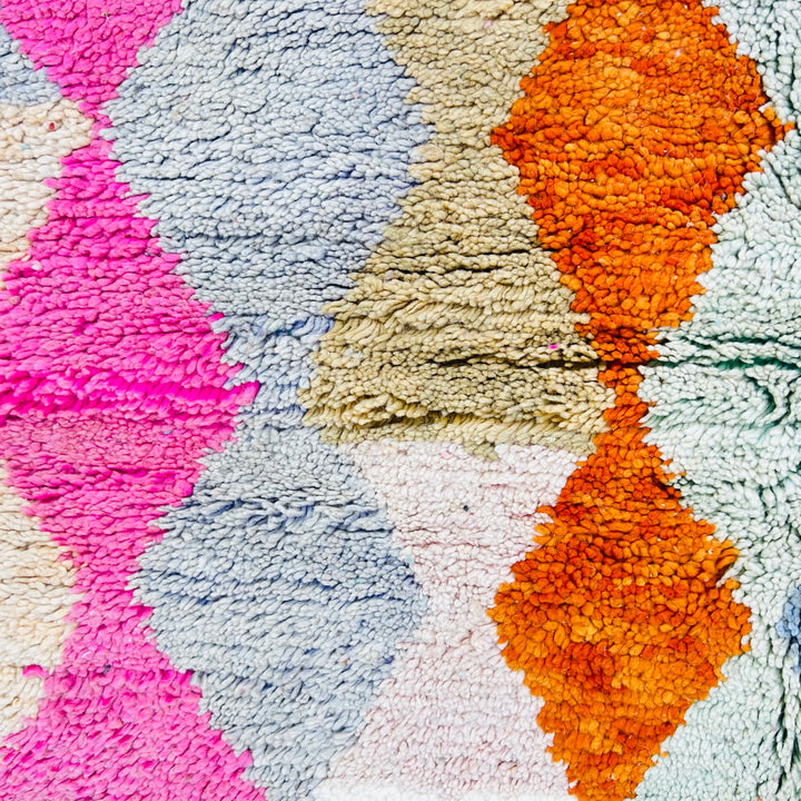 Vintage Moroccan wool rug with bold diamond pattern in pink, terracotta, charcoal, and turquoise hues. Area rug Moroccan style.
