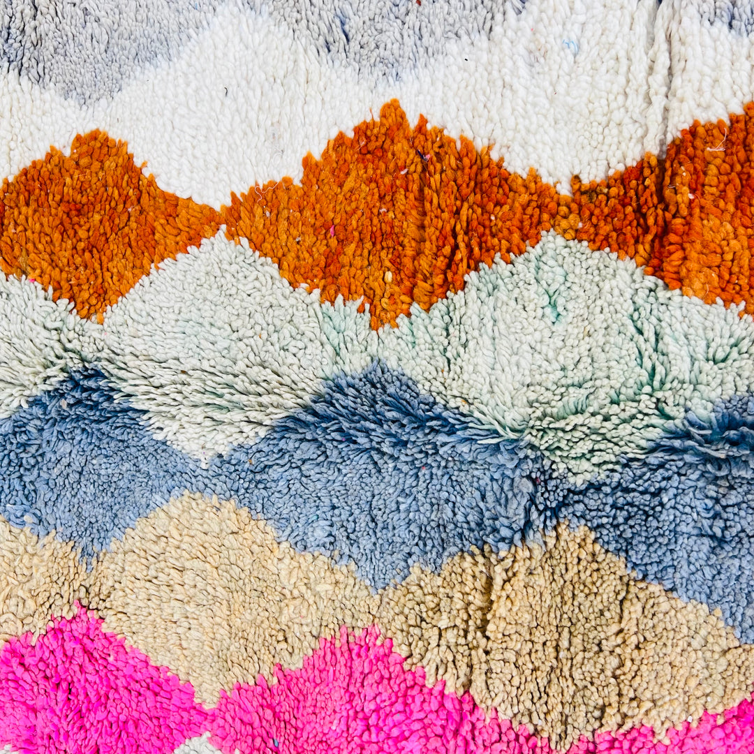 Vintage Moroccan wool rug with diamond pattern in pink, terracotta, charcoal, beige, and turquoise. Hand-knotted by Berber artisans.