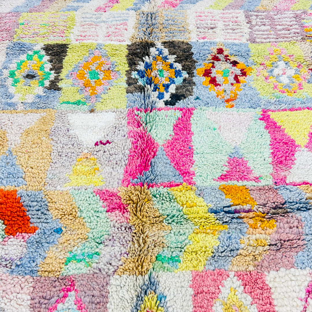 Vintage Moroccan Berber rug with colorful tribal motifs, zigzags, and diamonds. Wool textile, 253 x 153 cm, handmade by Berber women.