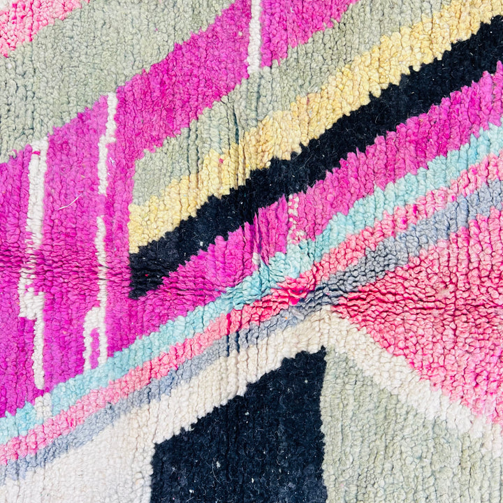 Colorful vintage Moroccan Berber rug with geometric patterns in pink, green, cream, and black wool - Traditional area decor.