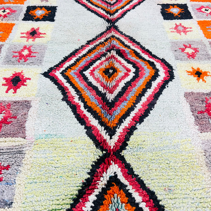 Vintage Moroccan rug with bold diamond motif, vibrant geometric stars, handmade by Berber artisans. Size: 260 × 155 cm.