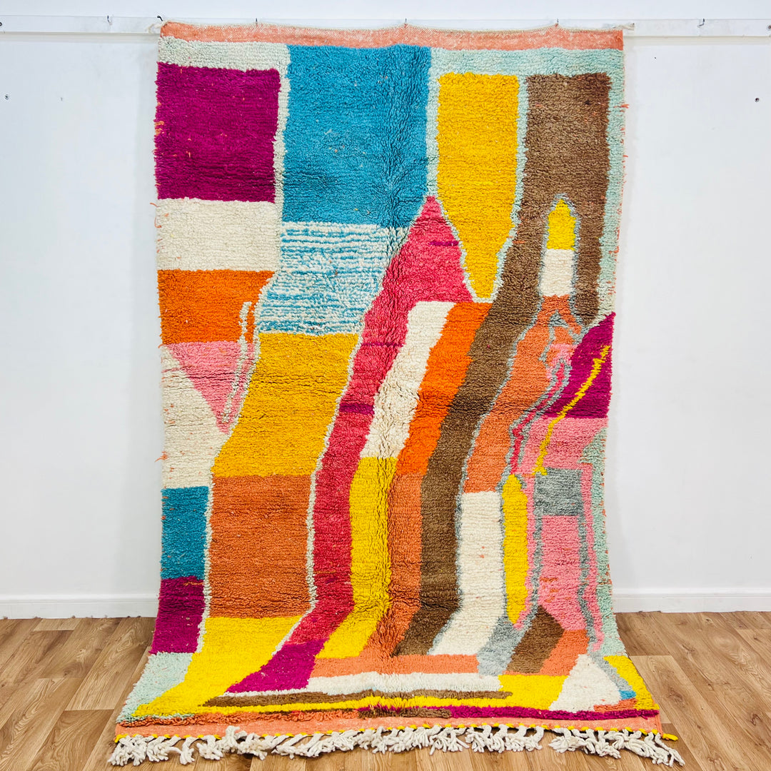 Vintage Moroccan rug with colorful geometric patterns in magenta, turquoise, yellow, orange; handwoven wool, 241 x 154 cm.
