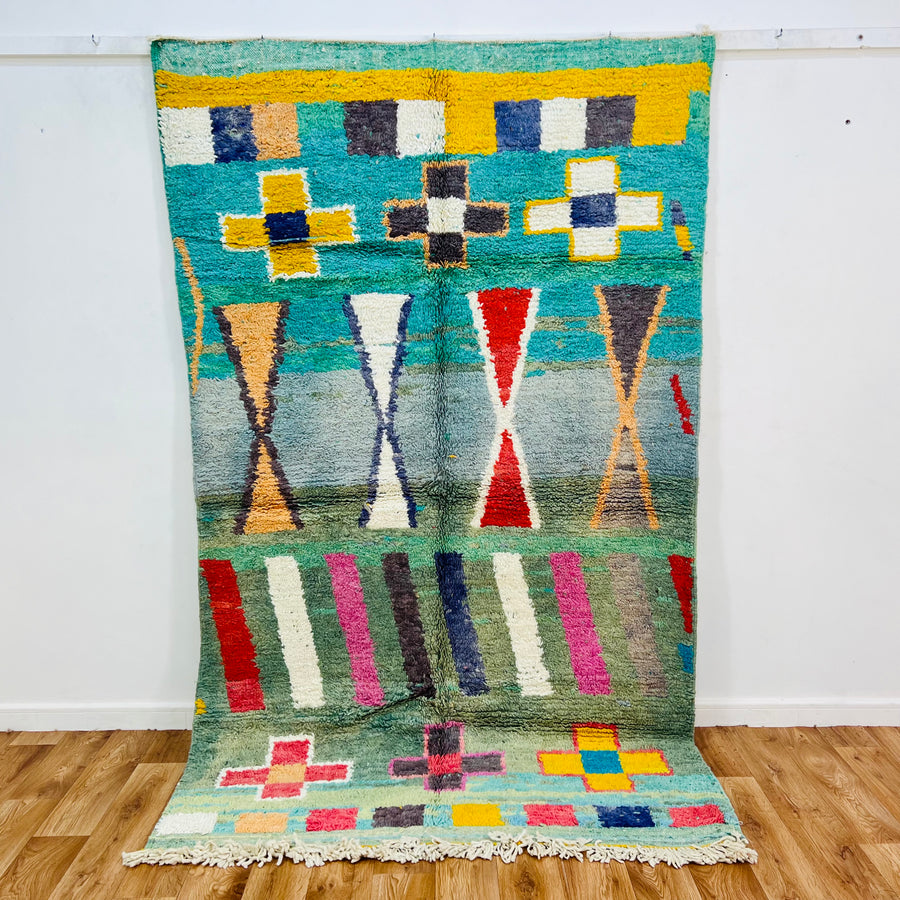 Vintage Moroccan rug with colorful geometric motifs and Berber design, featuring turquoise, red, and yellow accents, 291 x 146 cm.