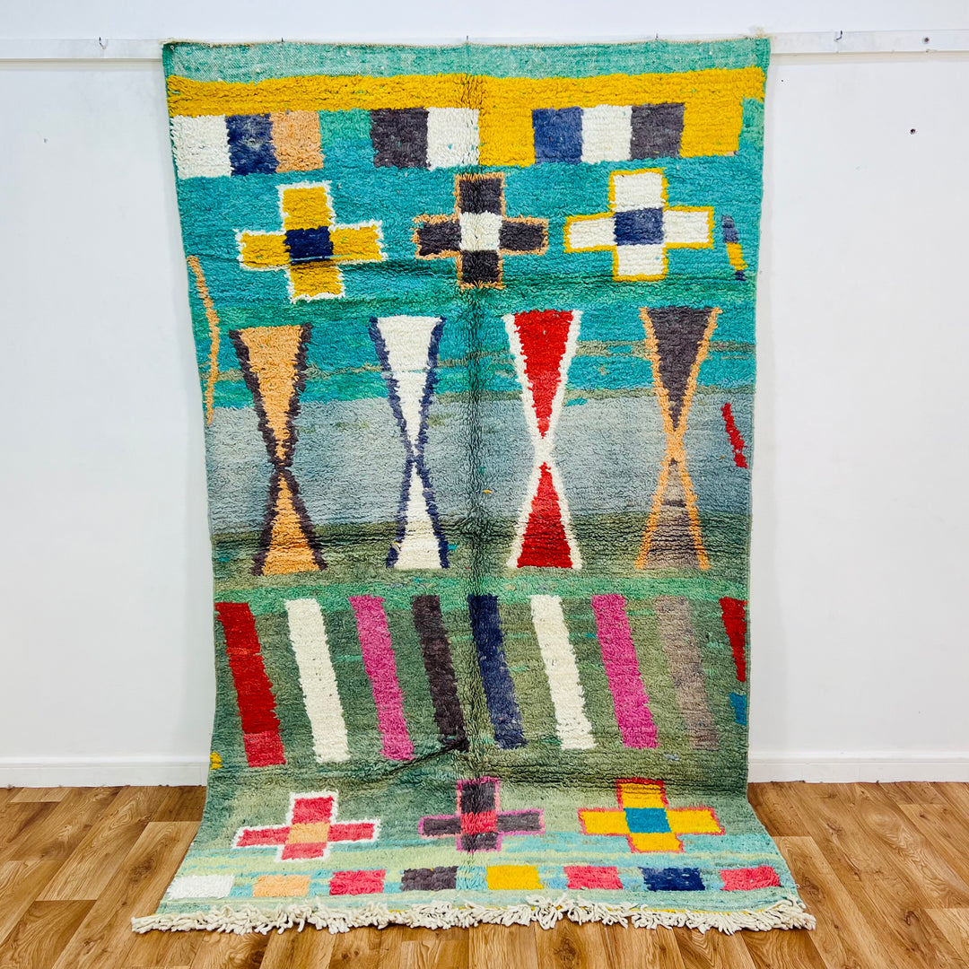 Vintage Moroccan rug with colorful geometric motifs and Berber design, featuring turquoise, red, and yellow accents, 291 x 146 cm.