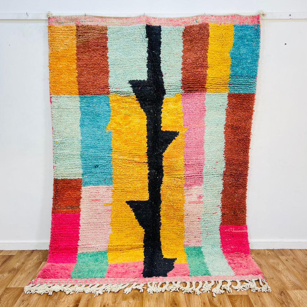 Vintage Moroccan rug with colorful stripes, handwoven wool, and abstract black pattern, perfect as a traditional Moroccan carpet.