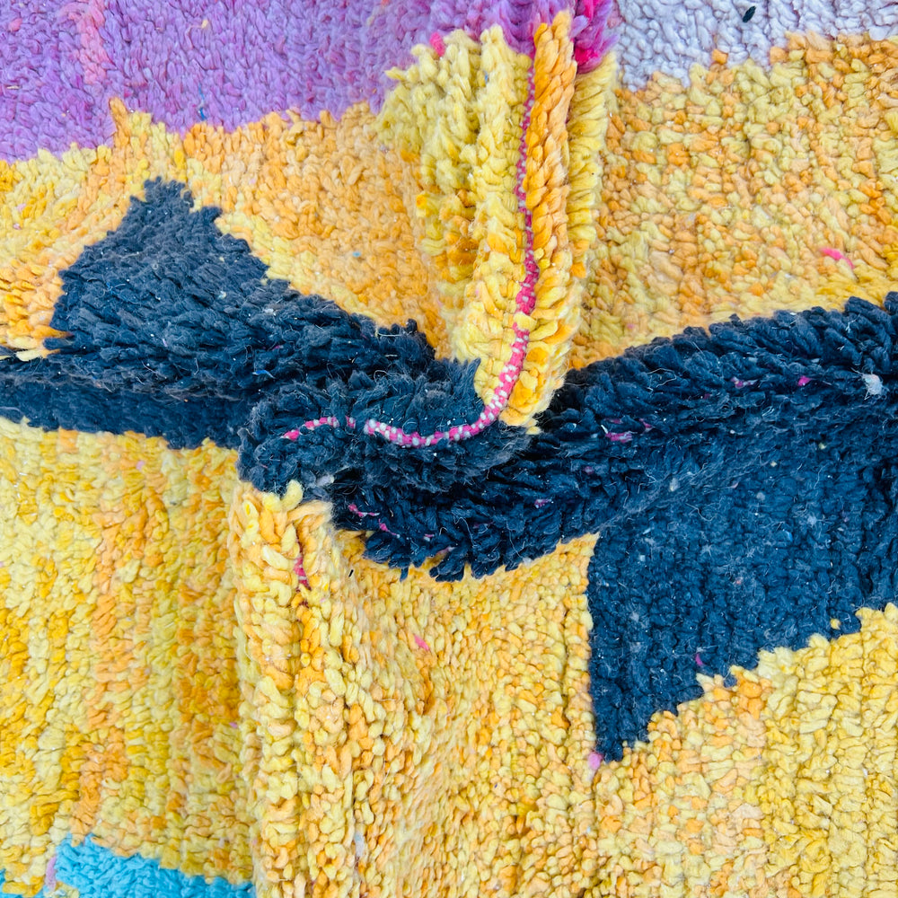 Colorful abstract vintage Moroccan wool rug with bold stripes and black central pattern, showcasing vibrant artisan craftsmanship.