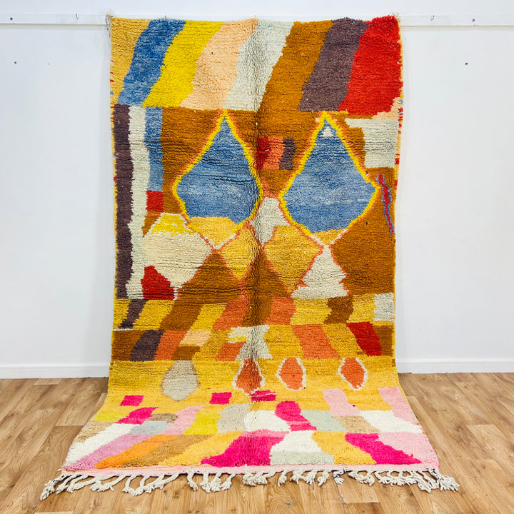 Vintage Moroccan Berber wool rug with vibrant blue diamond motifs, traditional Amazigh design, colorful earthy tones, 975x160 cm.