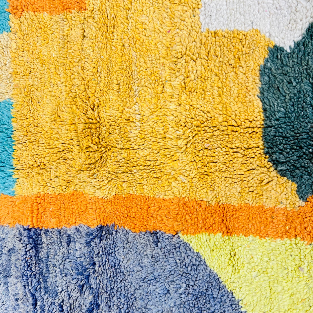 Bold abstract vintage Moroccan rug with yellow, turquoise, and orange geometric patterns. Handmade Berber wool, area rug from Morocco.