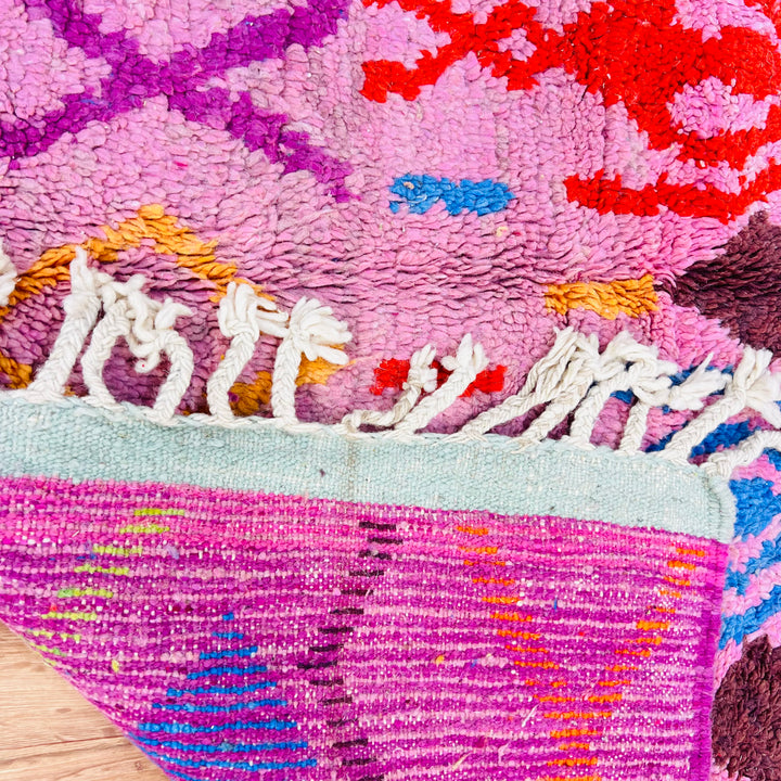 Pink Vintage Moroccan Rug with Berber motifs in red, orange, blue, and green, showcasing traditional Moroccan style and craftsmanship.
