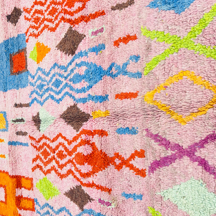 Pink vintage Moroccan rug with colorful geometric Berber motifs, handwoven in soft wool, size 246 x 157 cm, available for sale.