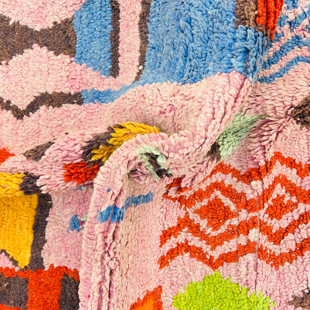 Colorful pink vintage Moroccan rug with geometric Berber motifs in blue, red, orange, green, and yellow. 246 x 157 cm.