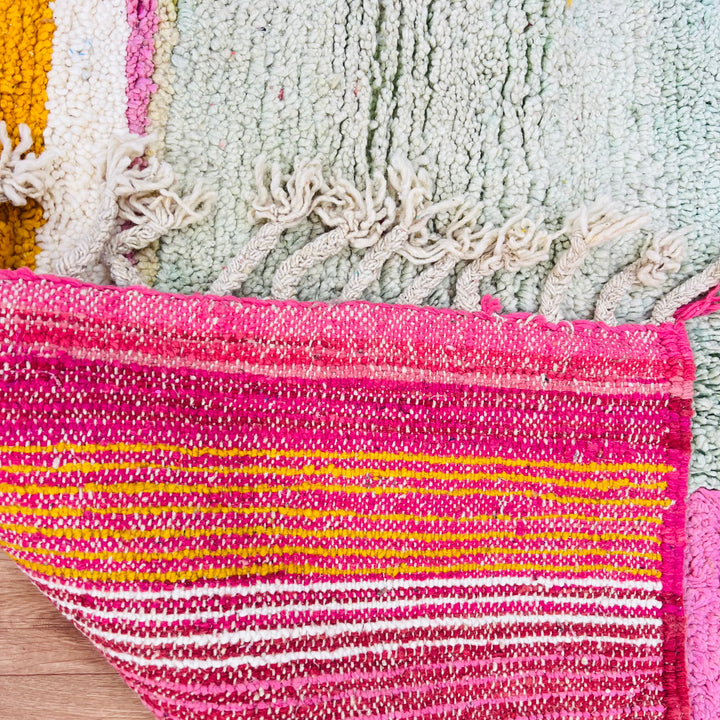 Vintage Moroccan Berber rug with pink, yellow, sage accents, showcasing intricate patterns, ideal for modern interiors.