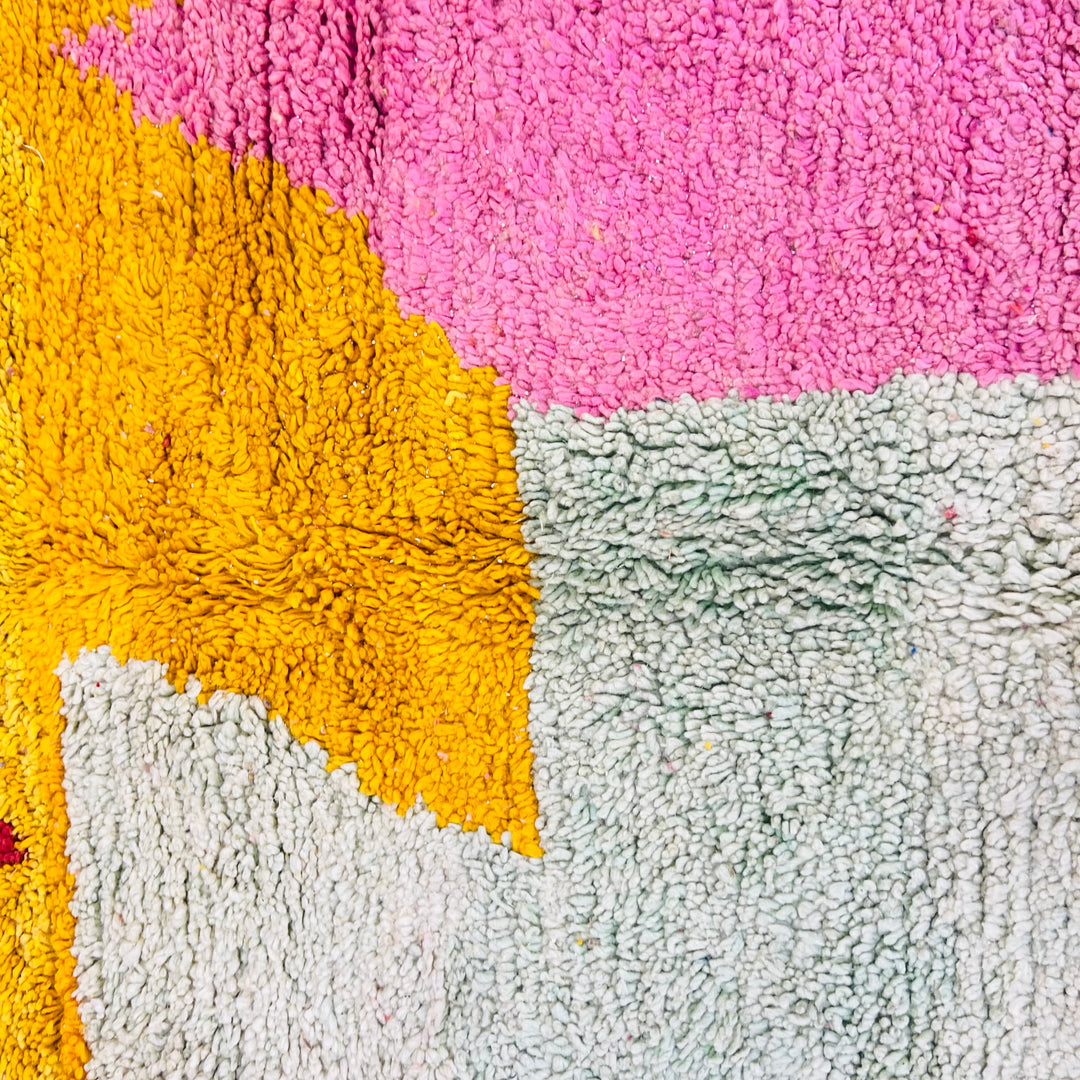 Bold abstract vintage Moroccan Berber rug with pink, yellow, and sage blocks, handmade wool, 8.3x5.2 ft, artistic interiors.