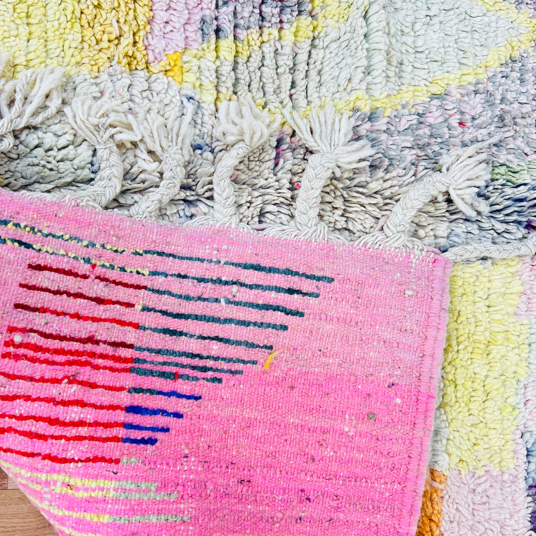 Close-up of a vibrant vintage Moroccan rug with colorful abstract patterns, showcasing intricate handwoven details.