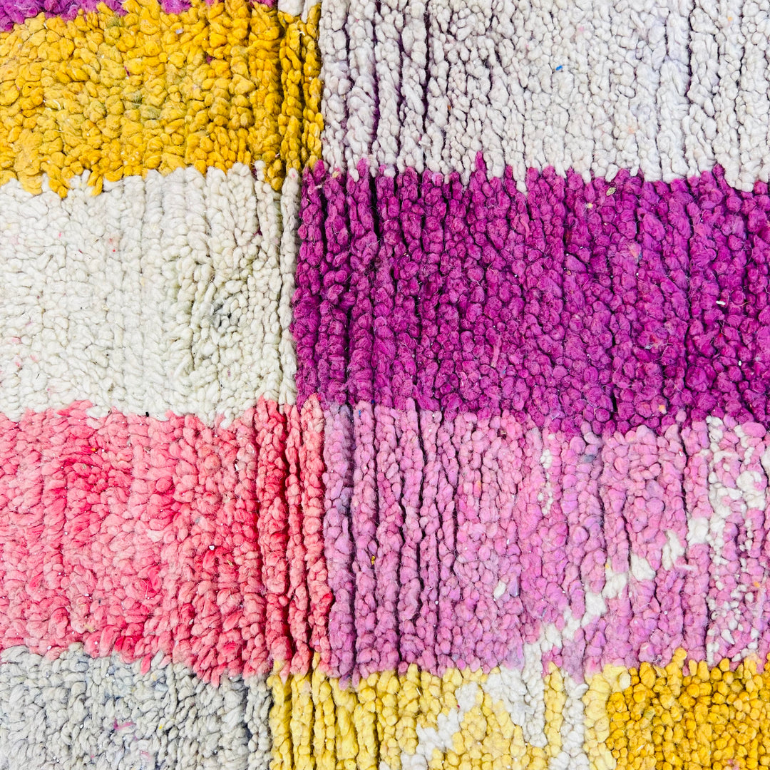 Colorful vintage Moroccan wool rug with geometric patterns in yellow, pink, and beige by Berber artisans, size 260 cm x 163 cm.