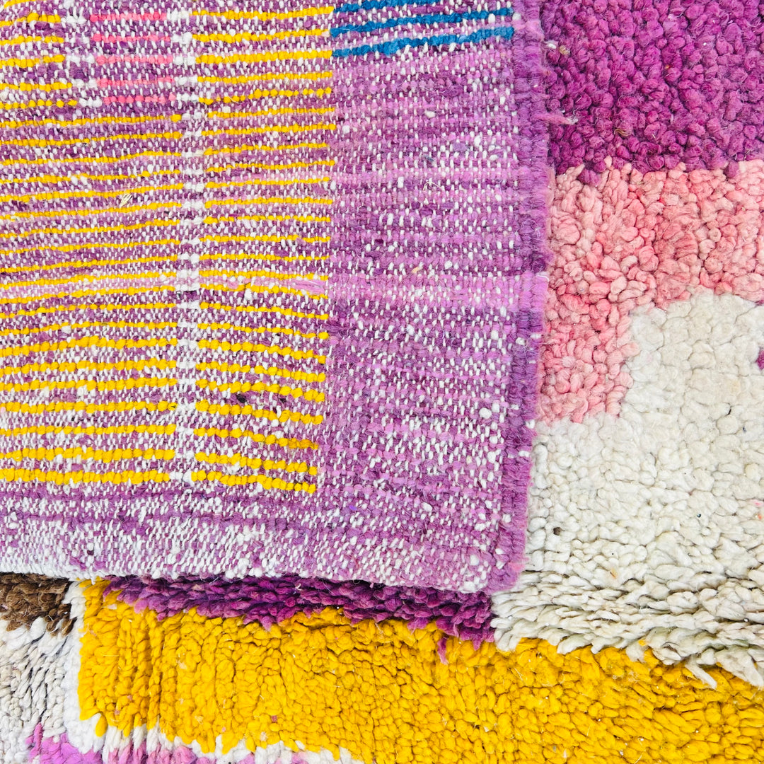 Vibrant vintage Moroccan wool rug with colorful geometric patterns, handwoven by Berber artisans; perfect for boho interiors.