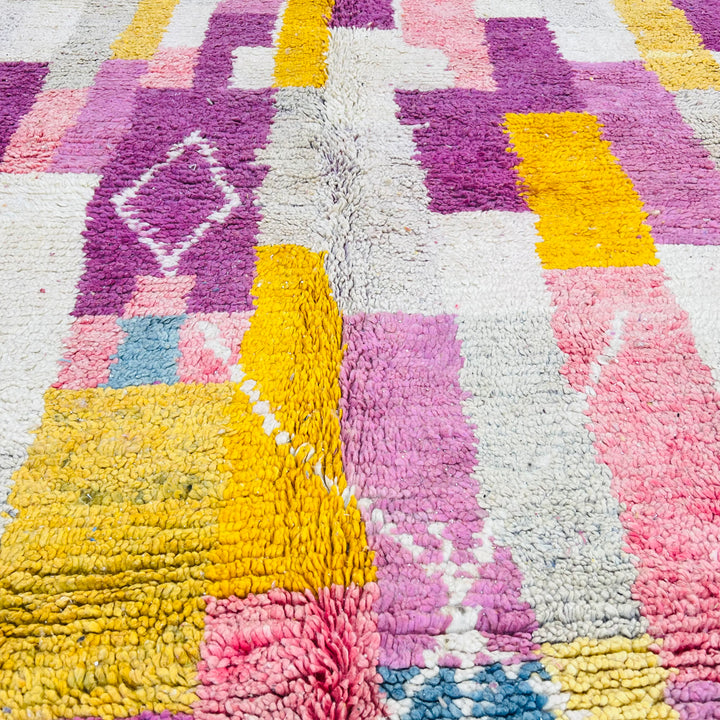 Vibrant vintage Moroccan wool rug with geometric patterns in pink, yellow, and orange. Handwoven Berber craftsmanship, 260 cm x 163 cm.