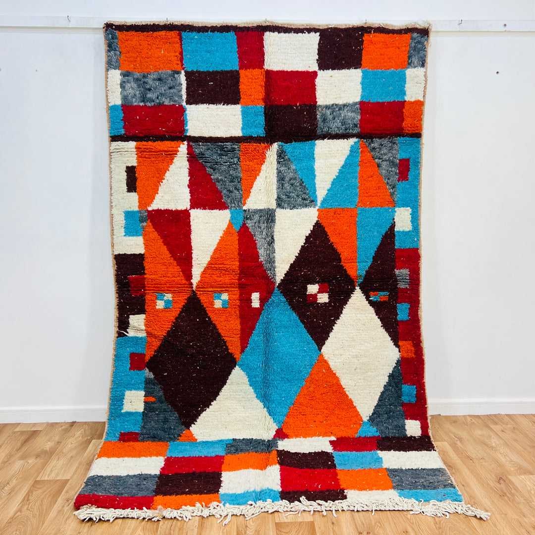 Bold geometric vintage Moroccan rug with vibrant colors, featuring diamonds in burnt orange, sky blue, and burgundy, 2260 x 155 cm.