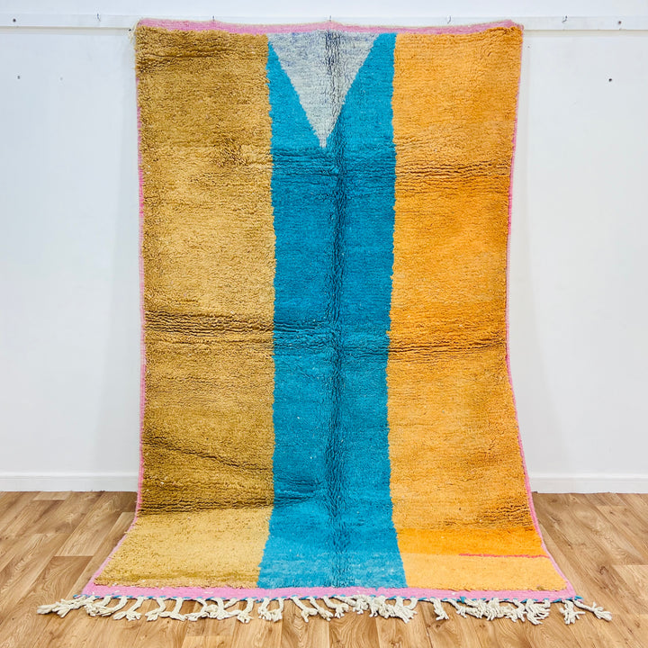 Modern Moroccan wool rug with bold color blocks in mustard, turquoise, and orange hues, handwoven by Berber artisans, size 8.3 x 5.3 ft.