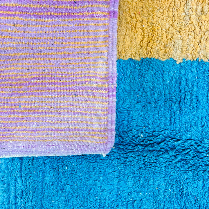 Modern Moroccan wool rug with mustard, turquoise, and pink color block design, showcasing Berber craftsmanship. Area rug 8.3 x 5.3 ft.