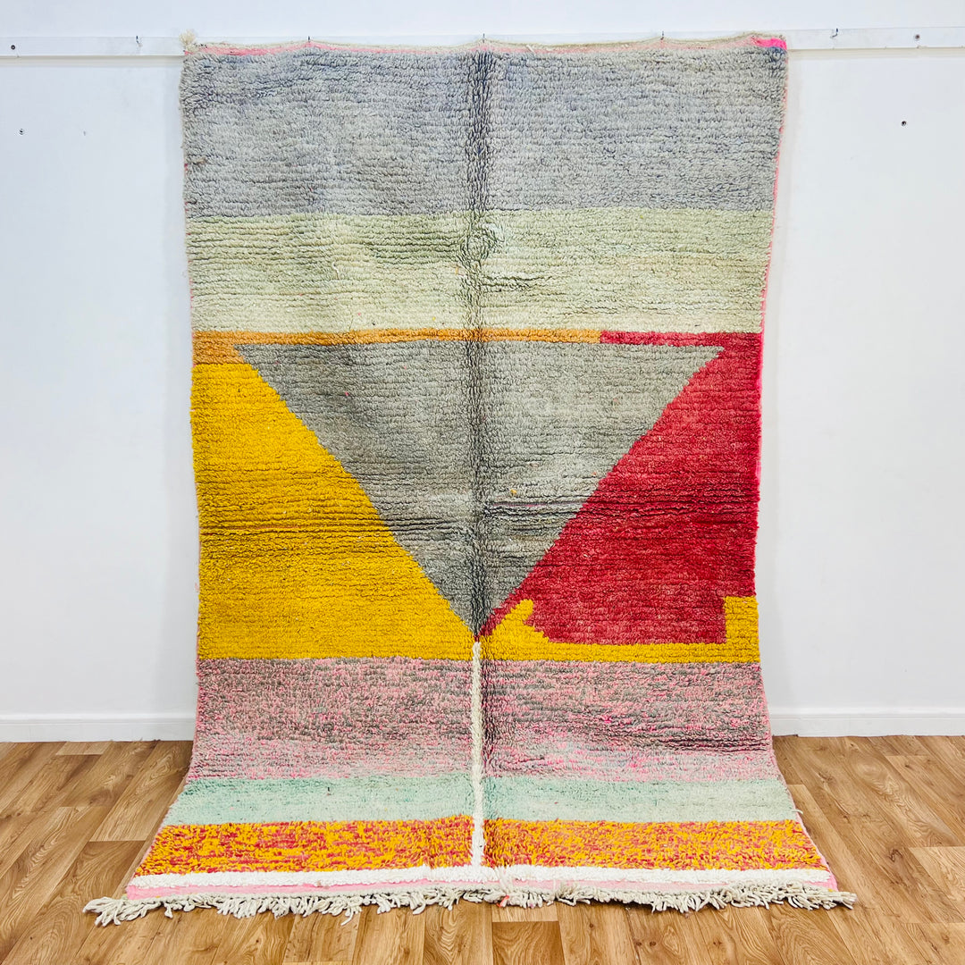 Handmade Moroccan wool rug with vibrant color blocks in mustard, gray, red, pink; 8.43 x 5.38 ft, Berber design.