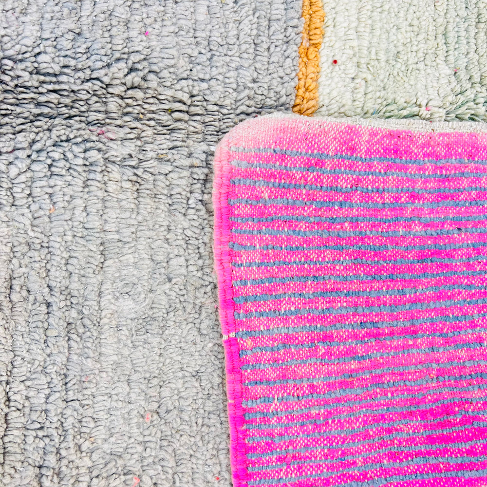 Color block Moroccan wool rug featuring pink, gray, and mustard abstract design. Handmade Berber carpet. Moroccan style rug.