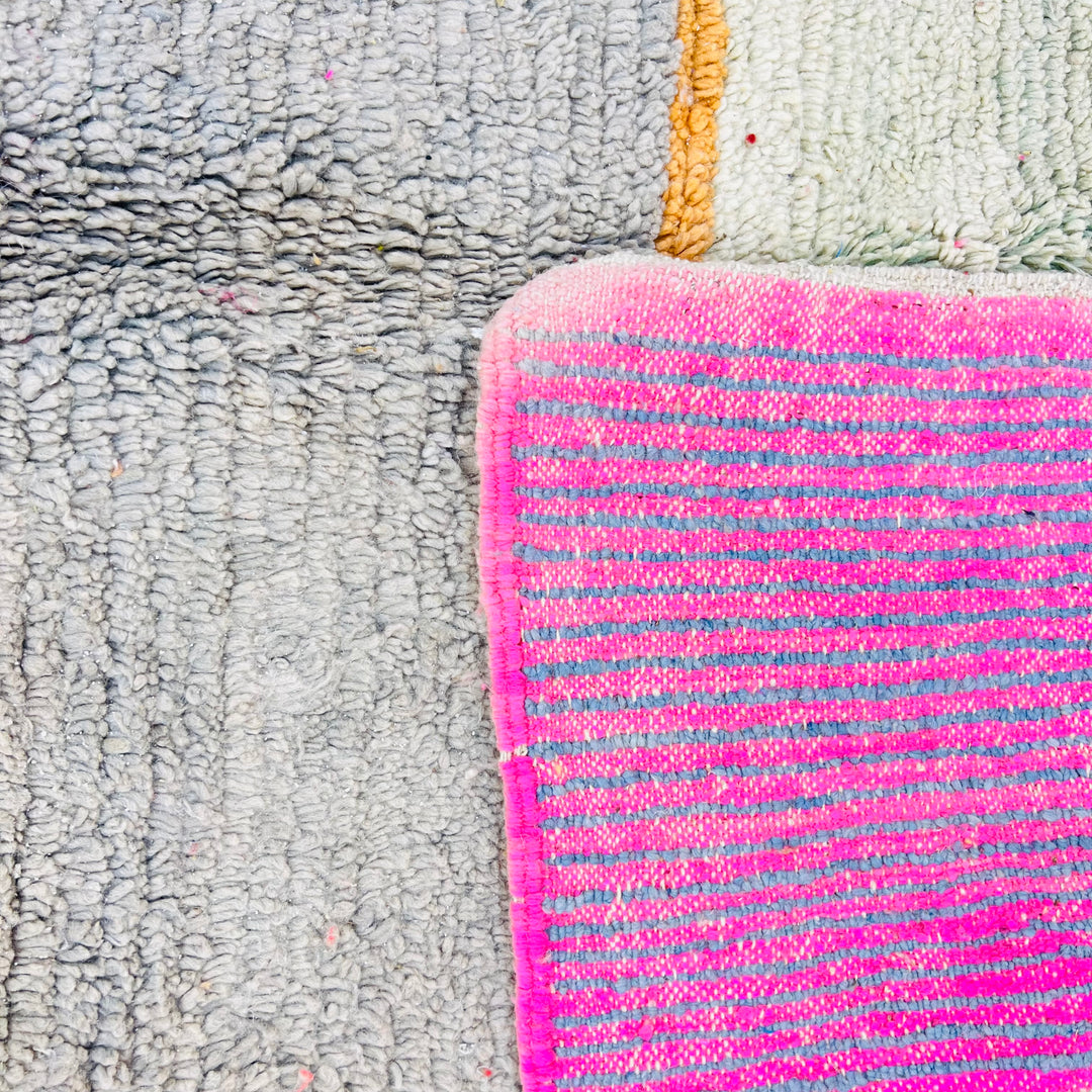 Color block Moroccan wool rug featuring pink, gray, and mustard abstract design. Handmade Berber carpet. Moroccan style rug.