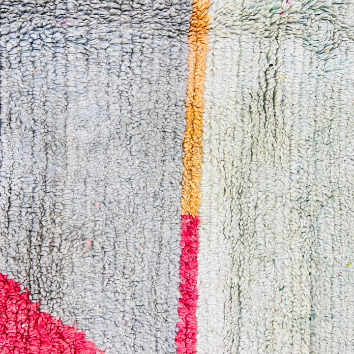 Color block Moroccan wool rug with mustard, gray, red, and pink triangular design, handmade Berber style, 257x164 cm.