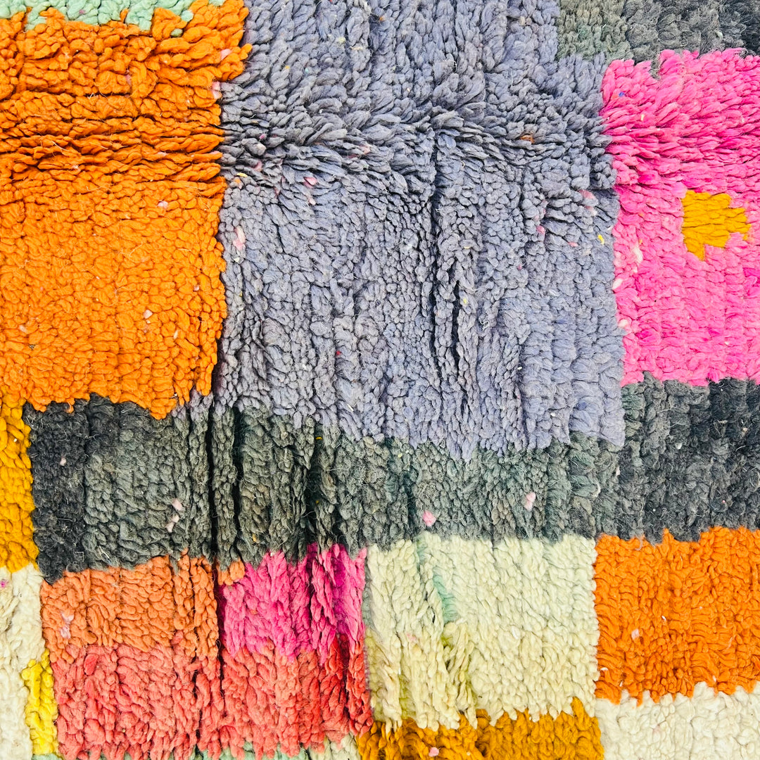 Colorful geometric handmade Moroccan rug with magenta, saffron, blush, and ivory tones, featuring bold Berber diamond accents.