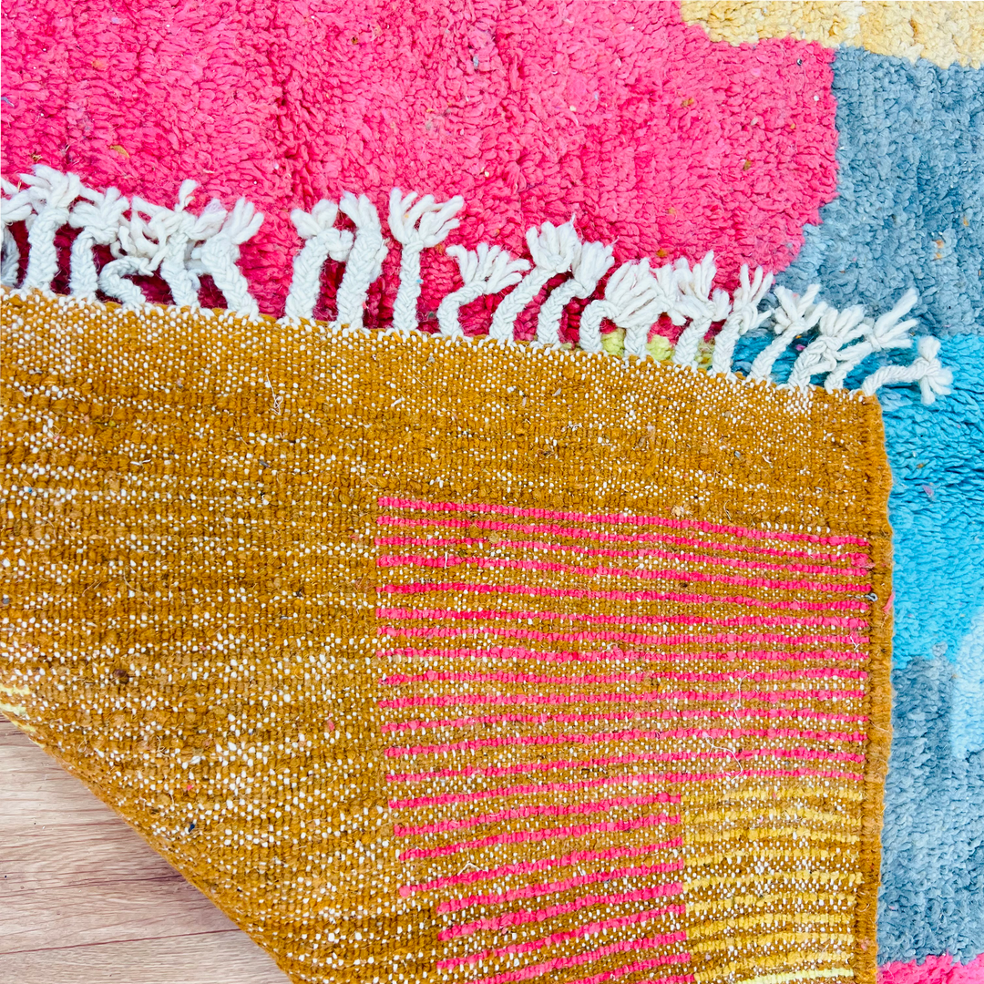 Colorful Vintage Moroccan Rug with abstract patterns in mustard yellow, coral pink, and turquoise. Handwoven Berber craftsmanship.