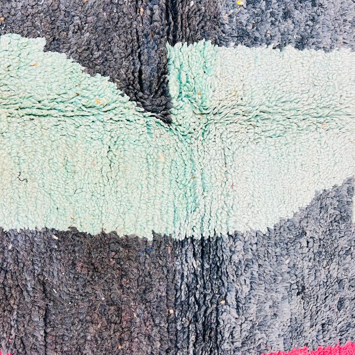 Colorful abstract vintage Moroccan rug with turquoise and black geometric patterns, showcasing traditional Berber craftsmanship.