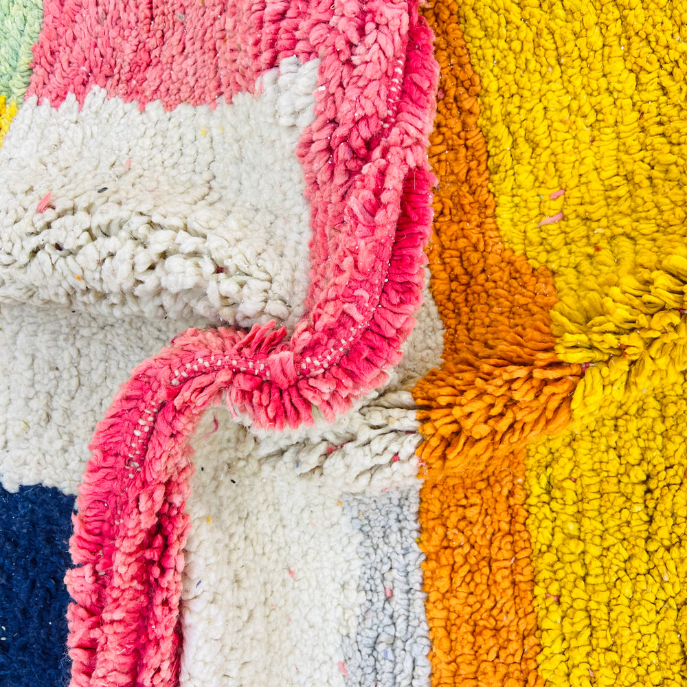 Colorful vintage Moroccan wool rug with bold patchwork design in navy, yellow, green, red, orange, and ivory. Handmade Moroccan Berber rug.