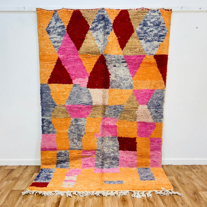 Colorful vintage Moroccan rug with diamond pattern; handmade wool carpet in red, coral, pink, and blue, 245 x 160 cm.
