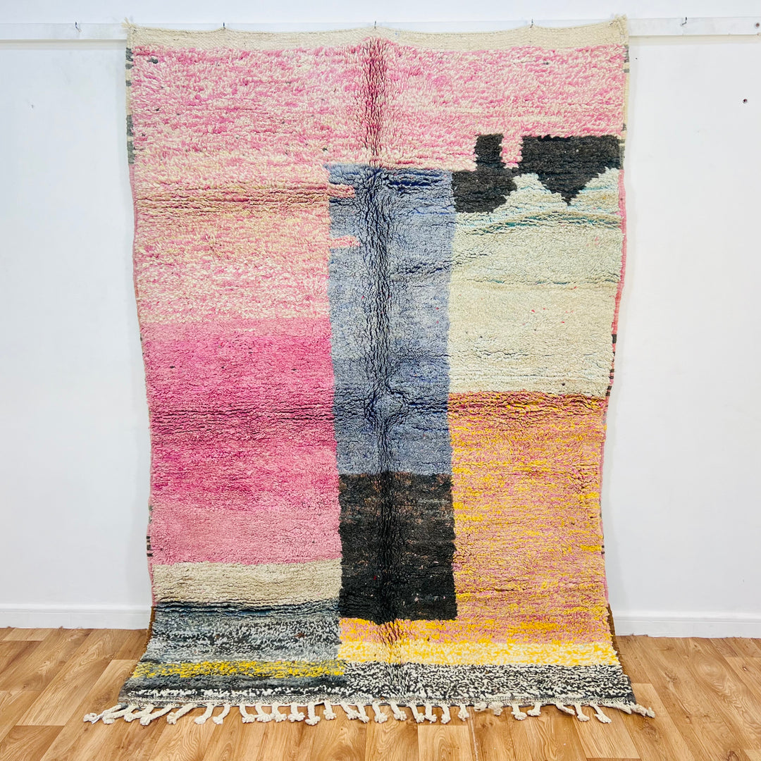 Vintage Moroccan wool rug with pink, blue, black, yellow, and cream blocks; handcrafted by Berber artisans. Size: 225 x 155 cm.