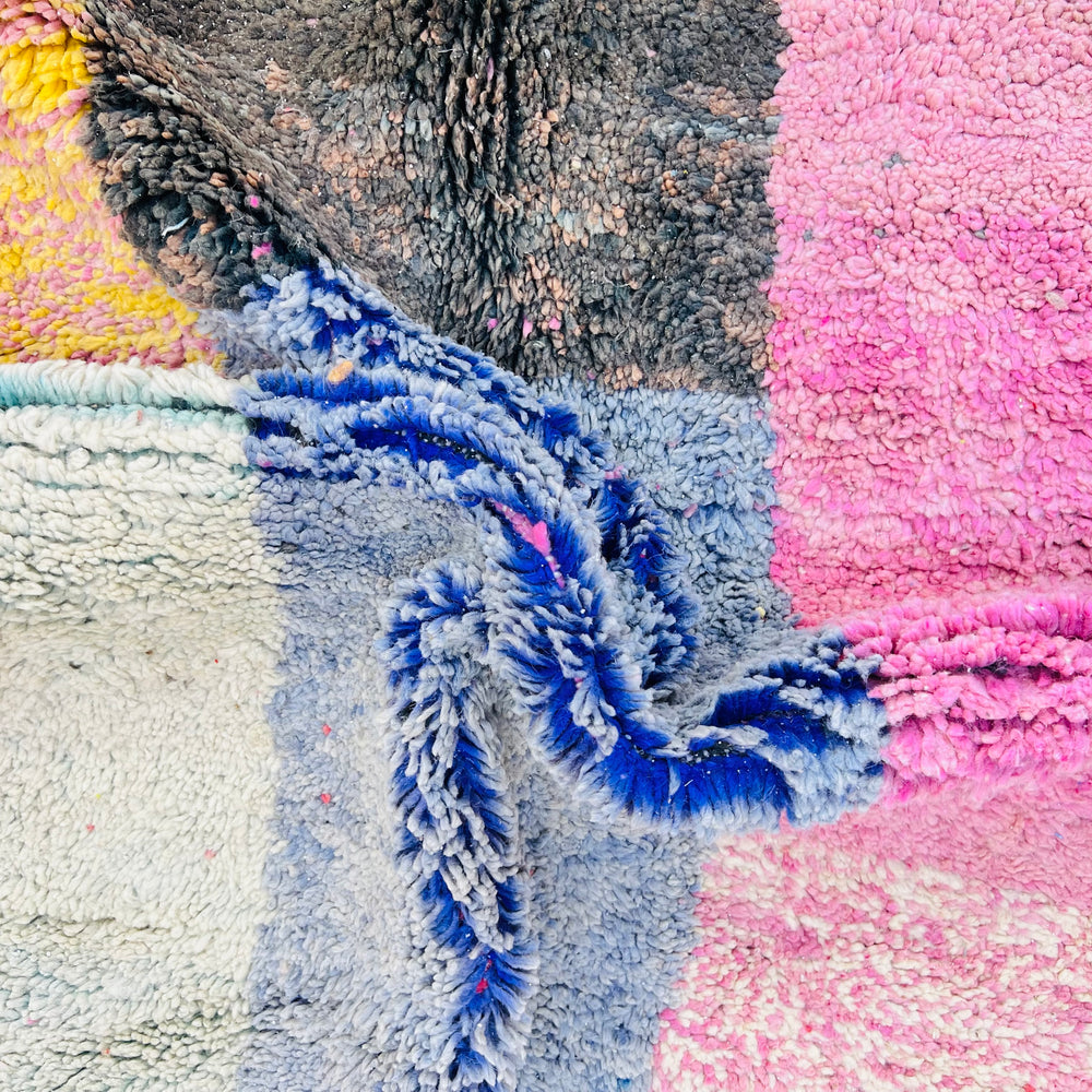 Colorful vintage Moroccan wool rug with pink, blue, and black blocks, handcrafted by Berber artisans. Ideal for vibrant decor.