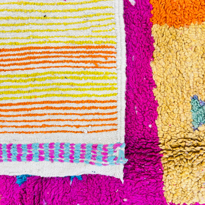 Vibrant fuchsia vintage Moroccan rug with bold Berber symbols, tribal patterns in yellow, orange, teal, blue, handmade wool, 250 x 157 cm.