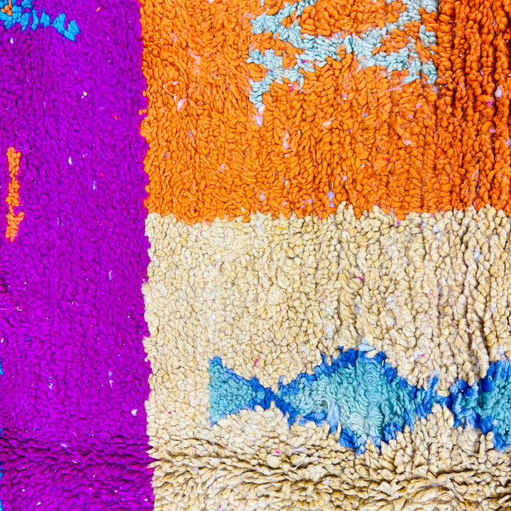 Colorful vintage Moroccan rug with fuchsia, orange, and teal Berber patterns, handwoven wool, tribal design.