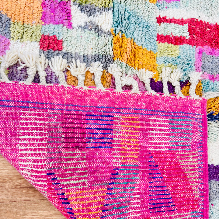Colorful Vintage Moroccan Rug with vibrant geometric patterns and fringed edges, handwoven by Berber artisans using premium wool.