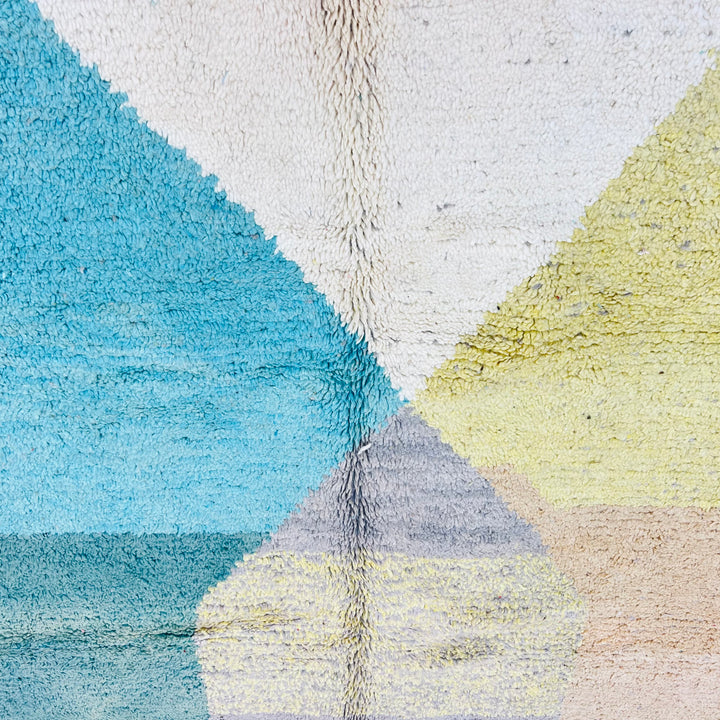 Geometric earth tone Moroccan rug with abstract design in beige, teal, mustard, and turquoise, handmade in the Atlas Mountains. Rug Nº 594.