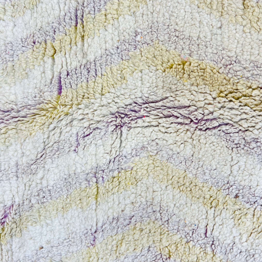 Close-up of Chevron Beige Vintage Moroccan Rug with pastel yellow and lilac lines, showcasing intricate handmade texture.