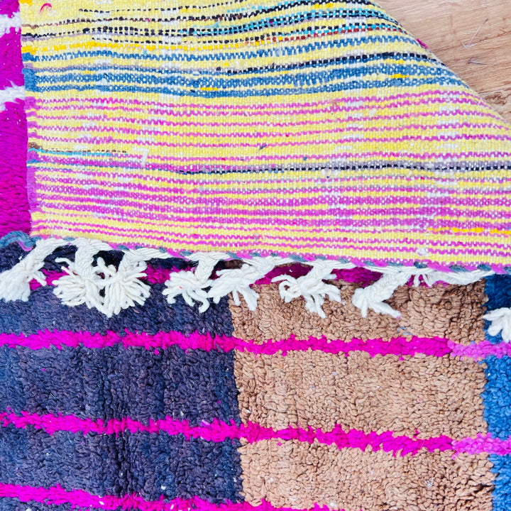 Colorful Moroccan vintage rug with fuchsia, orange, turquoise, yellow stripes and intricate motifs, showcasing Berber craftsmanship.