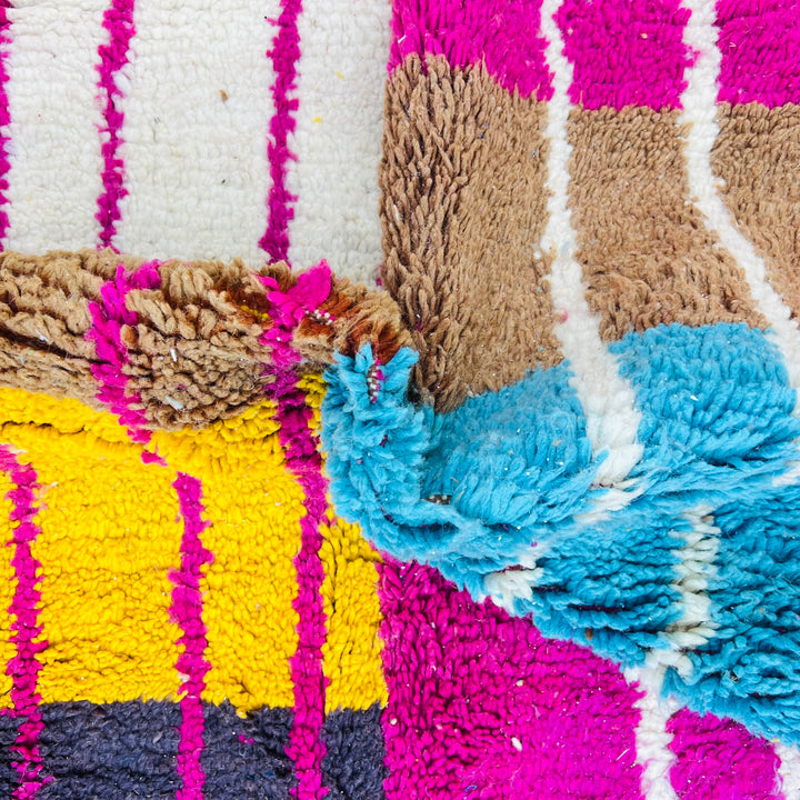 Colorful Moroccan vintage rug with fuchsia, orange, turquoise, and yellow patterns, showcasing Berber craftsmanship.