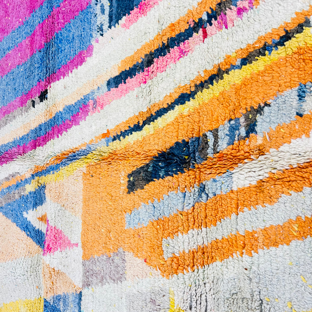 Close-up of a vintage colorful Moroccan rug with vibrant geometric designs. Perfect as a traditional Moroccan wool carpet.
