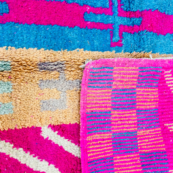 Vintage Moroccan Rug No. 636 – Colorful wool rug with tribal patterns and vertical stripes in pink, blue, yellow

