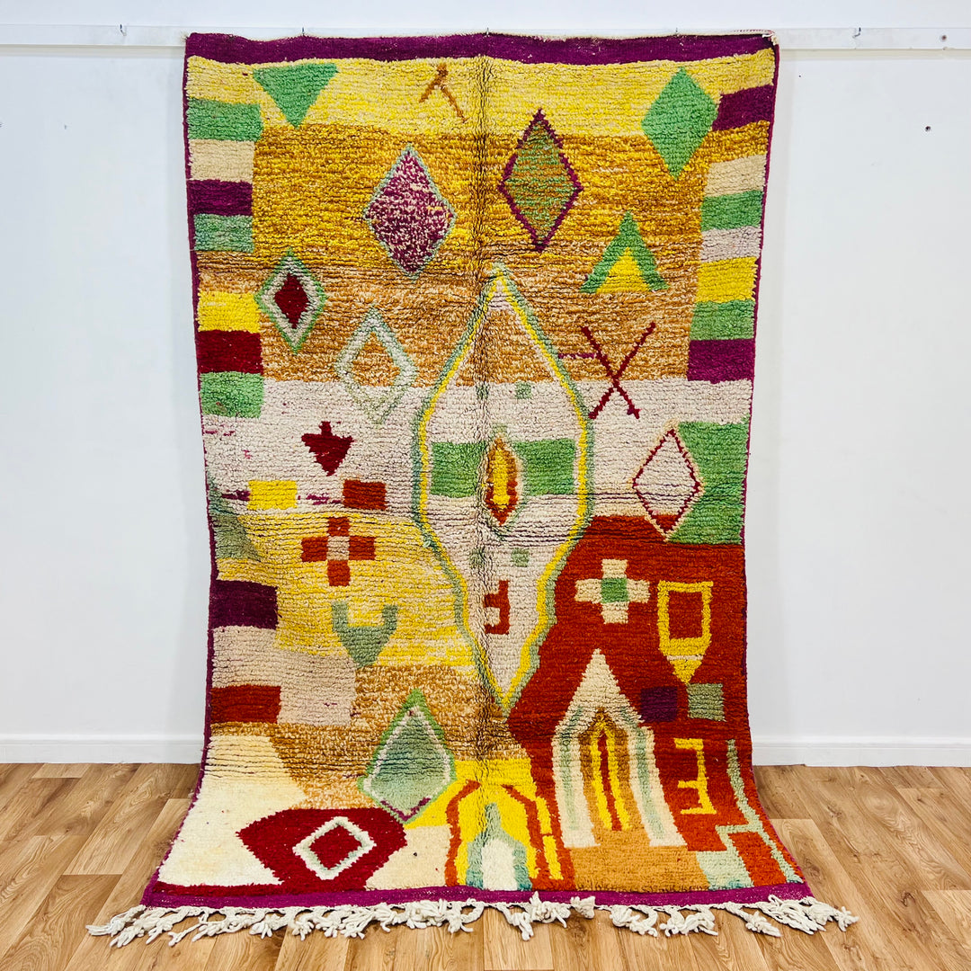Vintage Moroccan rug No. 653 with colorful geometric Berber motifs in yellow, green, and red wool

