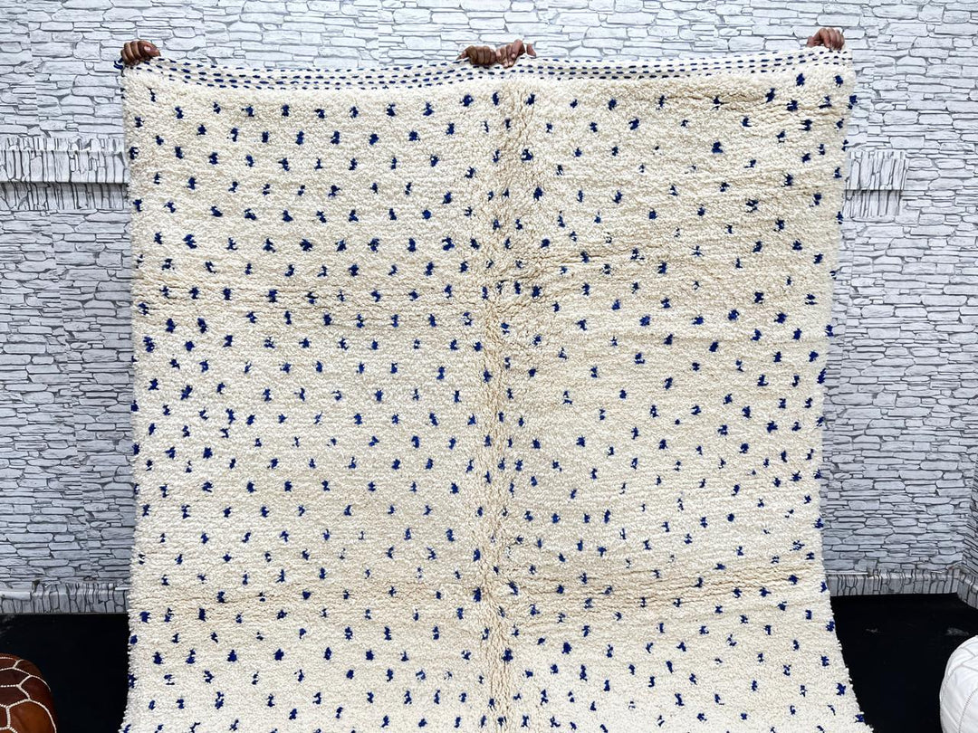 Handmade ivory Moroccan wool rug with blue dotted design – minimalist Berber rug