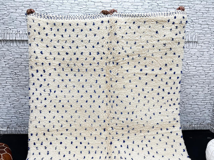 Handmade ivory Moroccan wool rug with blue dotted design – minimalist Berber rug