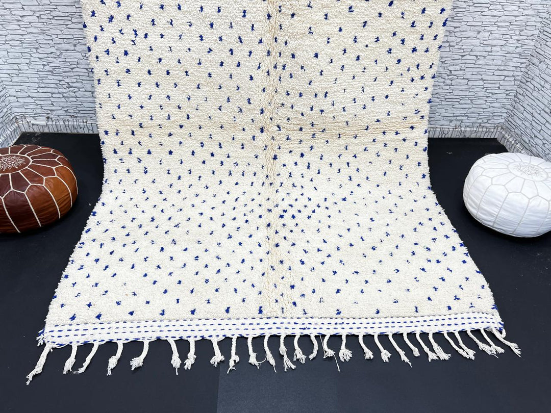 Handmade ivory Moroccan wool rug with blue dotted design – minimalist Berber rug