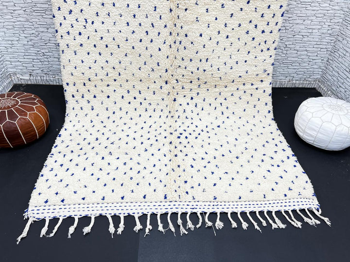 Handmade ivory Moroccan wool rug with blue dotted design – minimalist Berber rug
