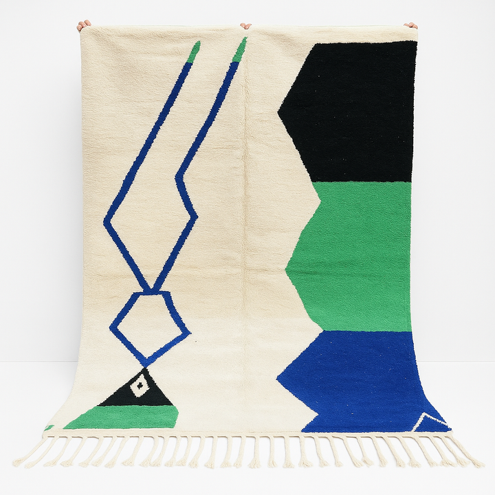 Handmade ivory Moroccan wool rug with green, blue, and black geometric abstract patterns